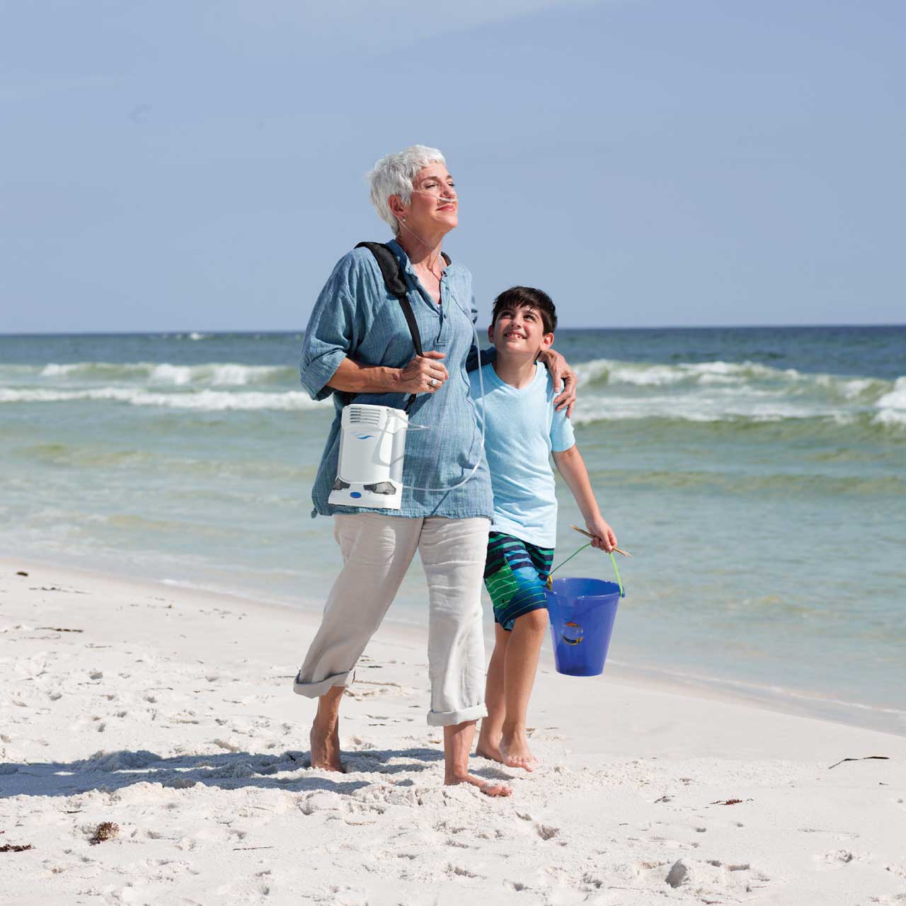 Caire FreeStyle Comfort Portable Oxygen Concentrator - Patient walking at the beach
